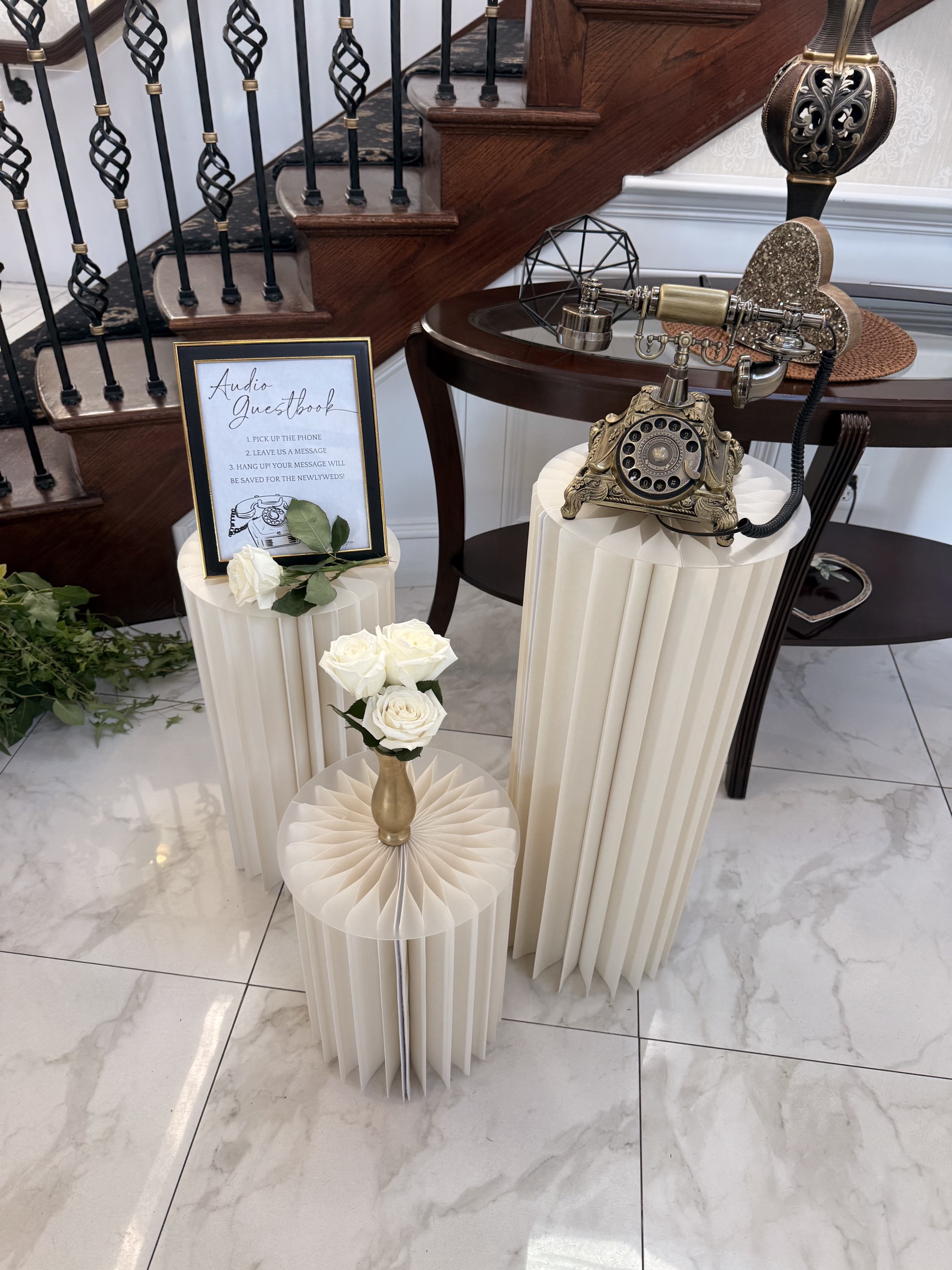 Welcome table beside the grand staircase at The Mansion at Glen Cove