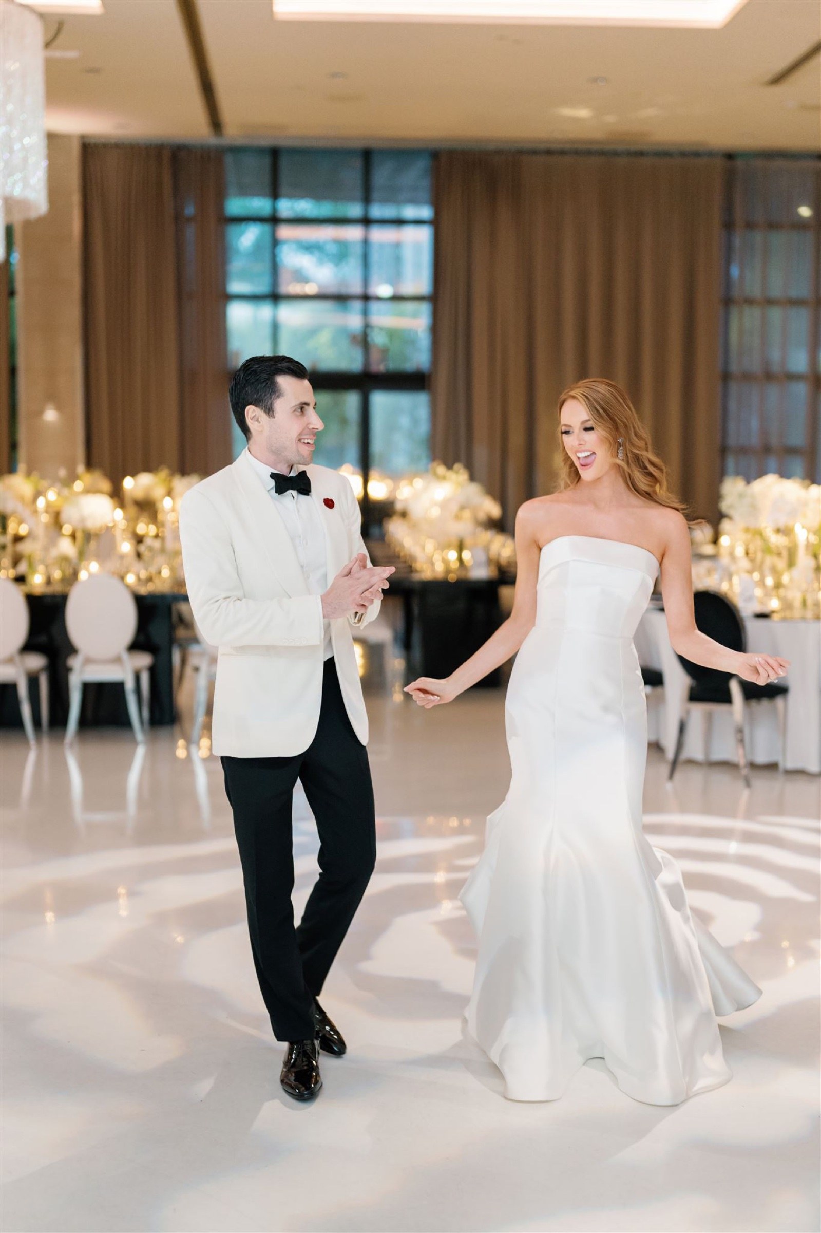 Newlyweds dancing on the patterned dance floor at the Ravel Hotel
