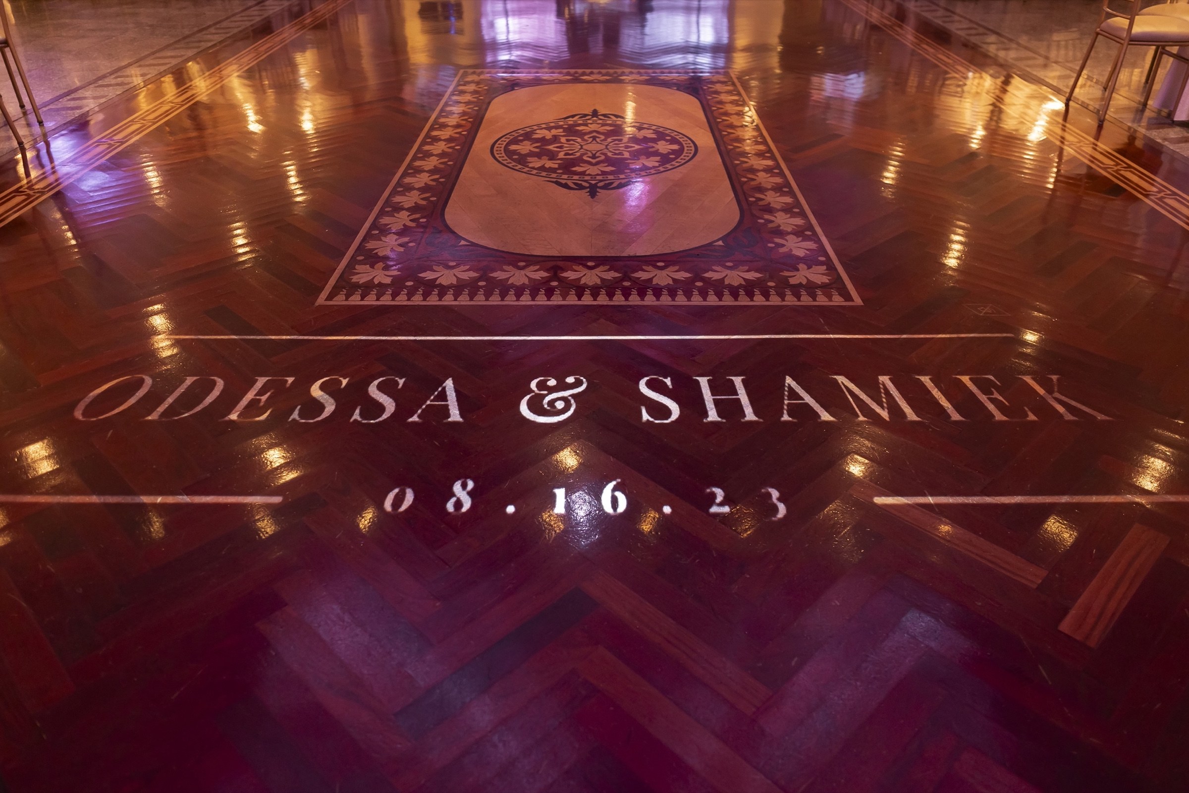Custom name-in-lights monogram projected on the dance floor at Sand Castle