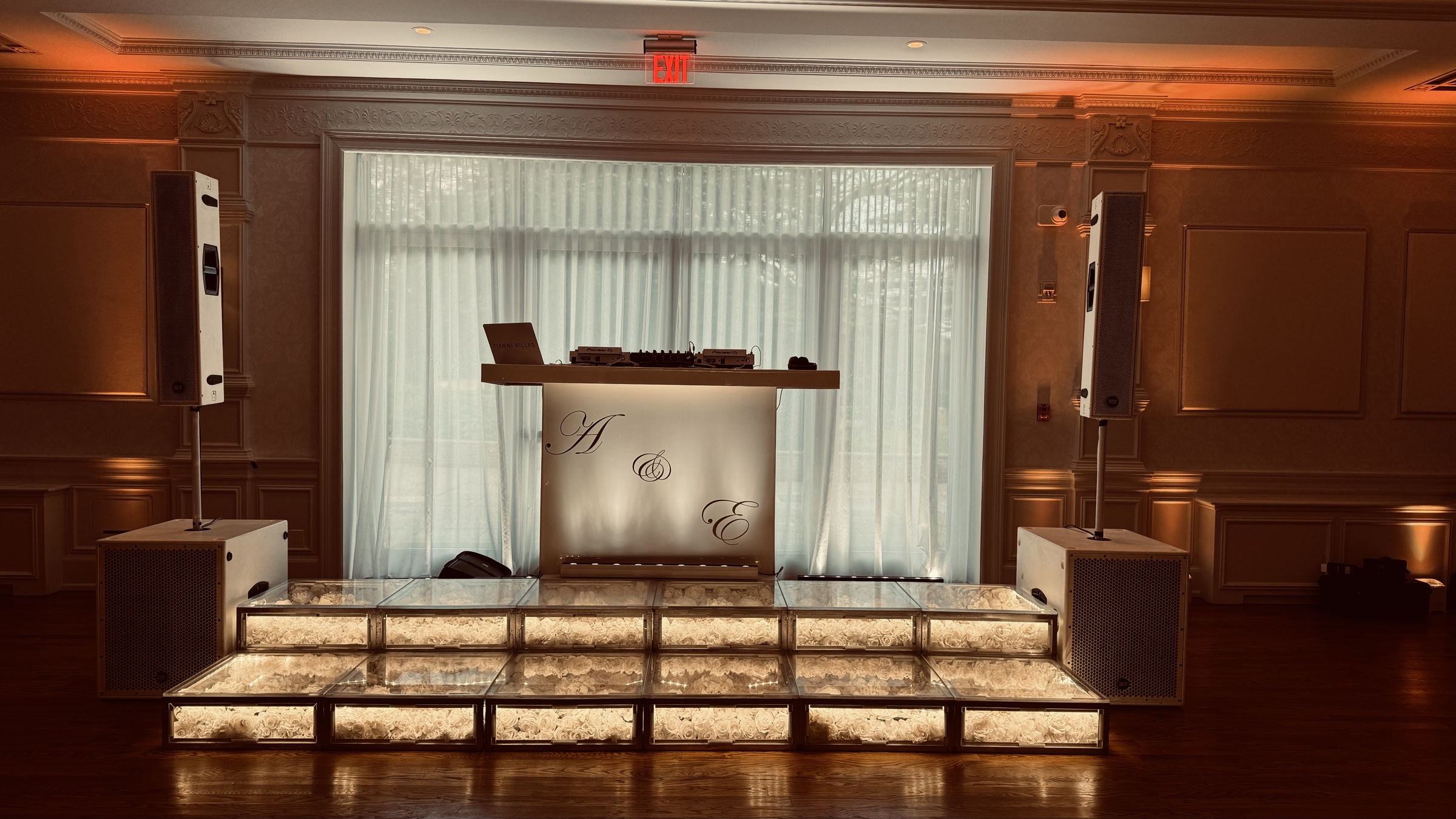 Custom monogram DJ booth on a lit stage at The Lannin